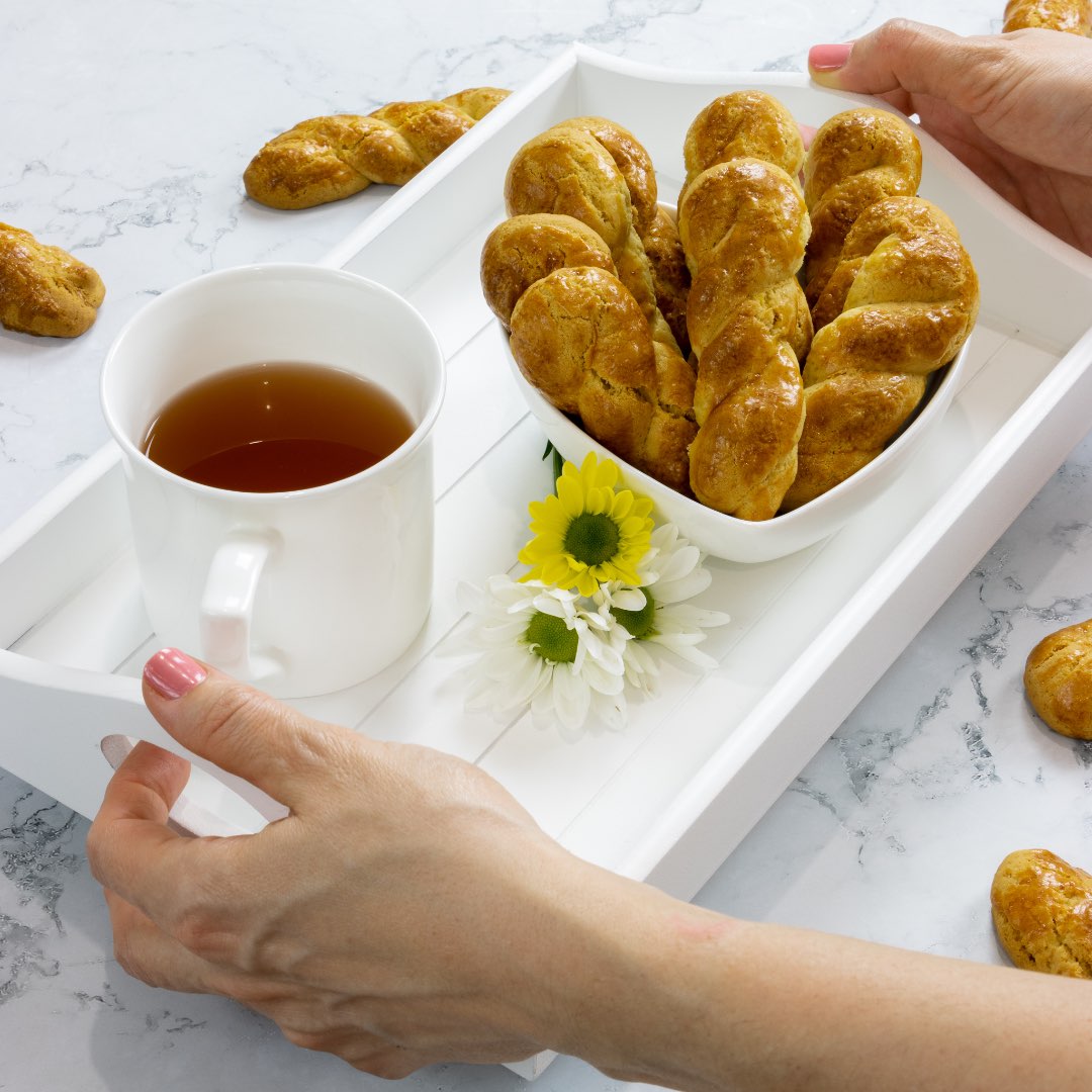 Greek biscuits - Koulourakia smyrneika - served on a white tray with a cup of tea