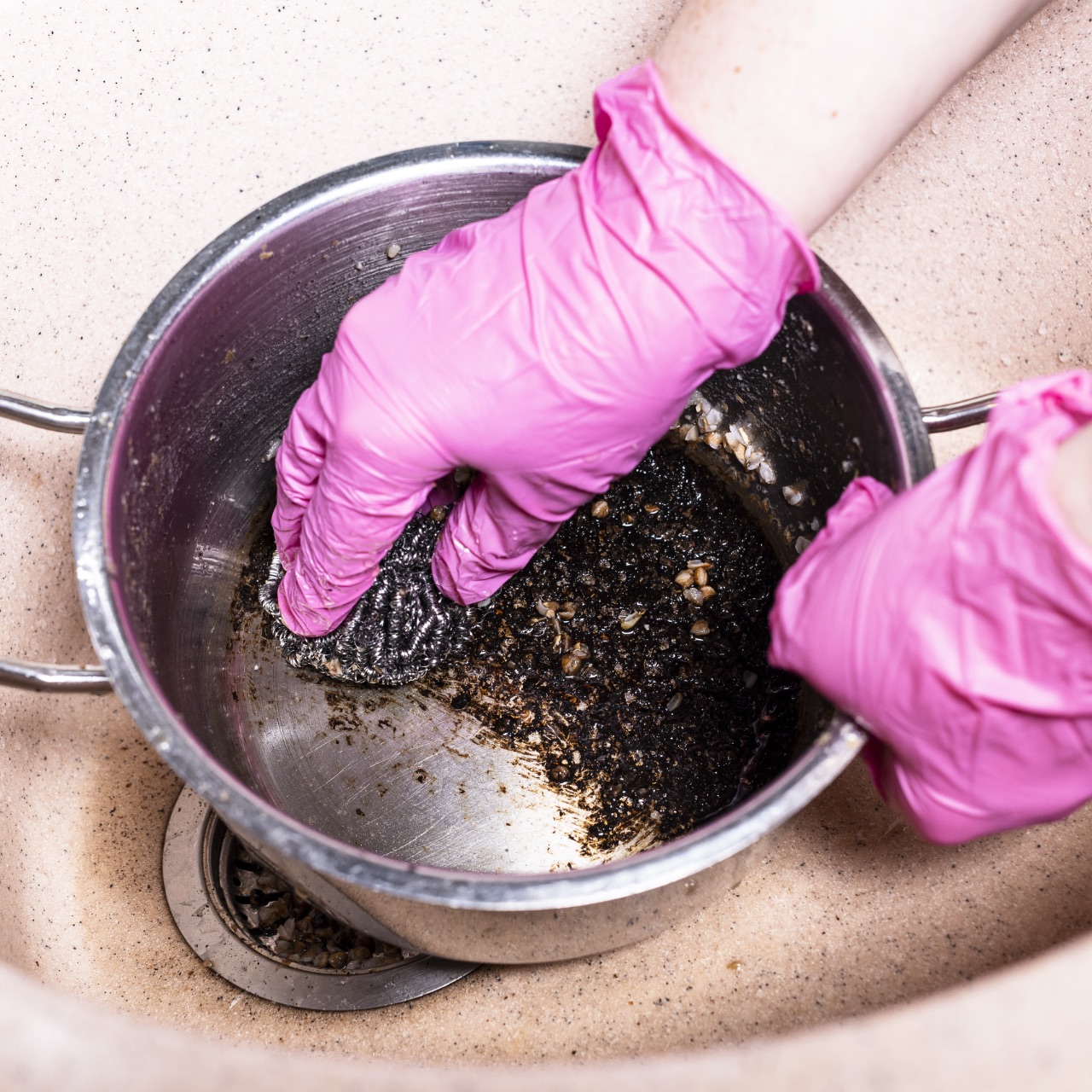 Scrubbing burnt pot with metal sponge
